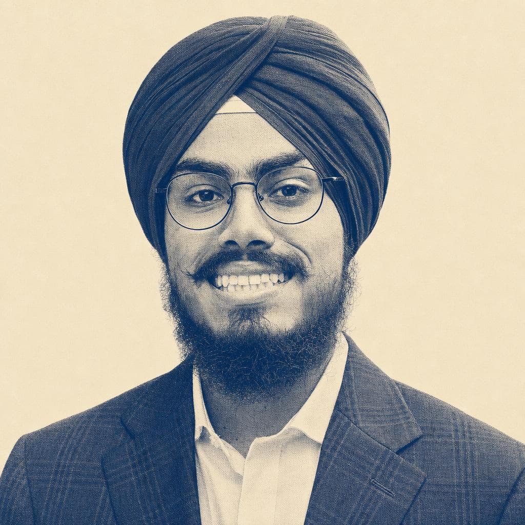 Dilzafer Singh, in a red dastar and glasses, photographed smiling on campus.