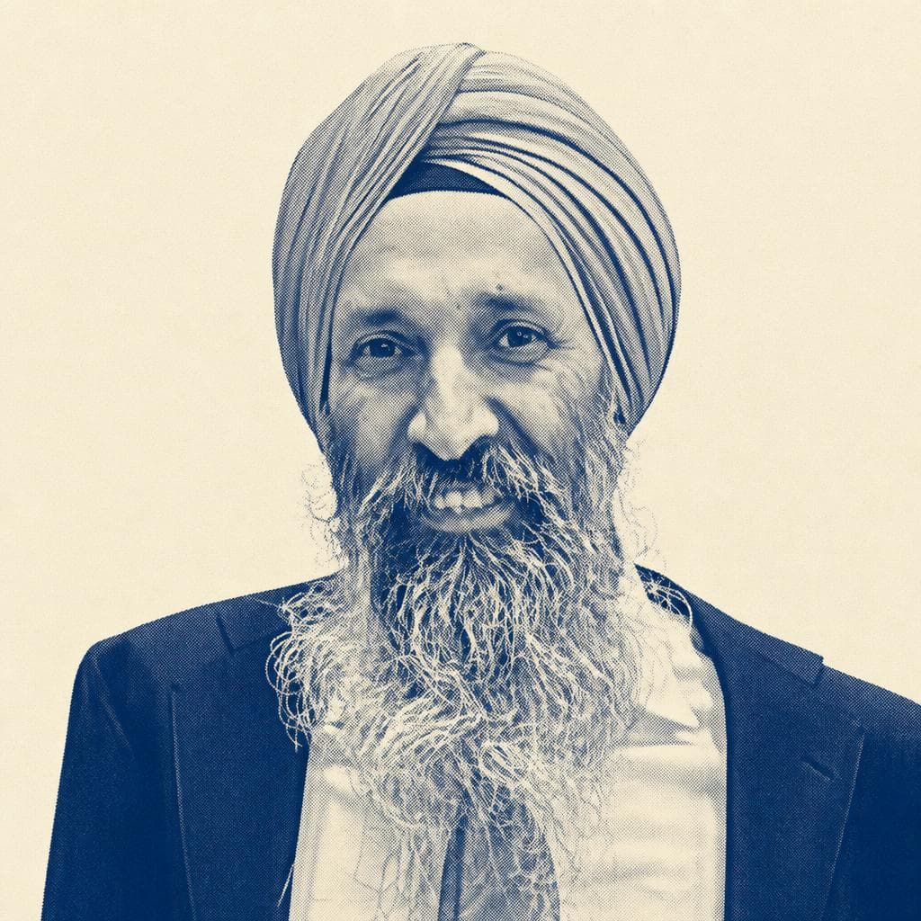 Harjinder Singh, in a tan dastar and dark blazer, photographed smiling.