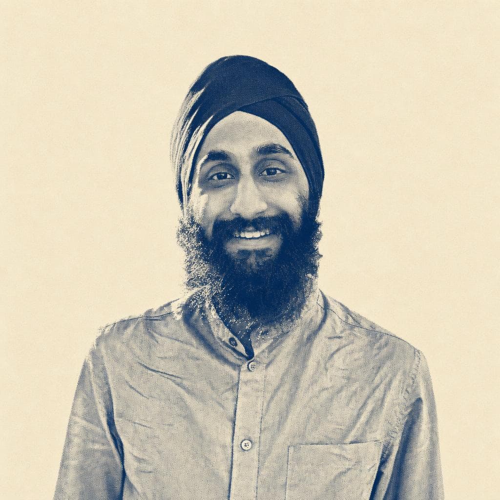 Karanbir Singh, in a navy dastar, photographed outdoors by the Brooklyn Bridge.