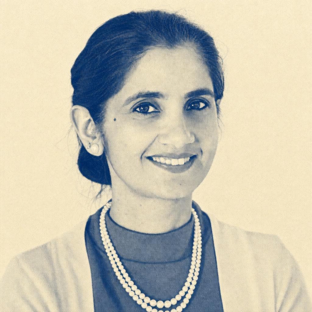 Sumit Kaur, wearing pearls, photographed smiling.