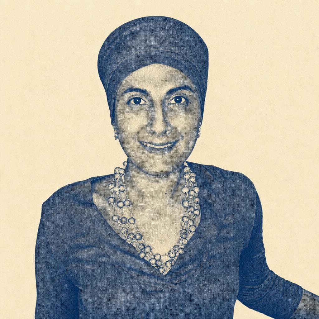 Supreet Kaur, in a rose head covering and pink top.